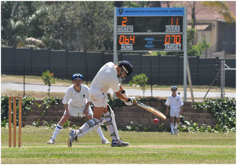 Cricket action with CLOX scoreboard